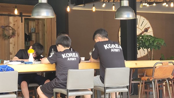 강원도 평창군 봉평의 한 카페에서 ‘KOREA ARMY’ 상징이 박힌 티셔츠를 가족끼리 맞춰 입고 휴식을 취하고 있는 군인가족.