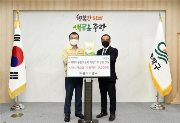 류경기 중랑구청장(왼쪽)이 장세환 ㈜유비이엔지 대표로부터 KF94 마스크 5000매를 전달받고 기념촬영을 하고 있다. (사진=중랑구 제공)