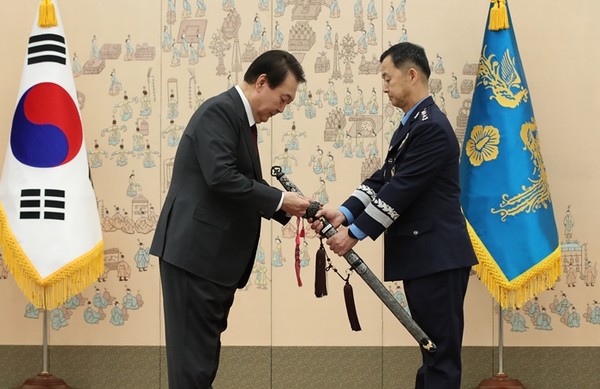 윤석열 대통령이 7일 서울 용산 대통령실 청사에서 열린 각군 중장 18명 보직 신고 및 삼정검 수치 수여식에서 윤병호 공군참모차장 삼정검에 수치를 달아주고 있다 (사진=대통령실통신사진기자단 연합뉴스)